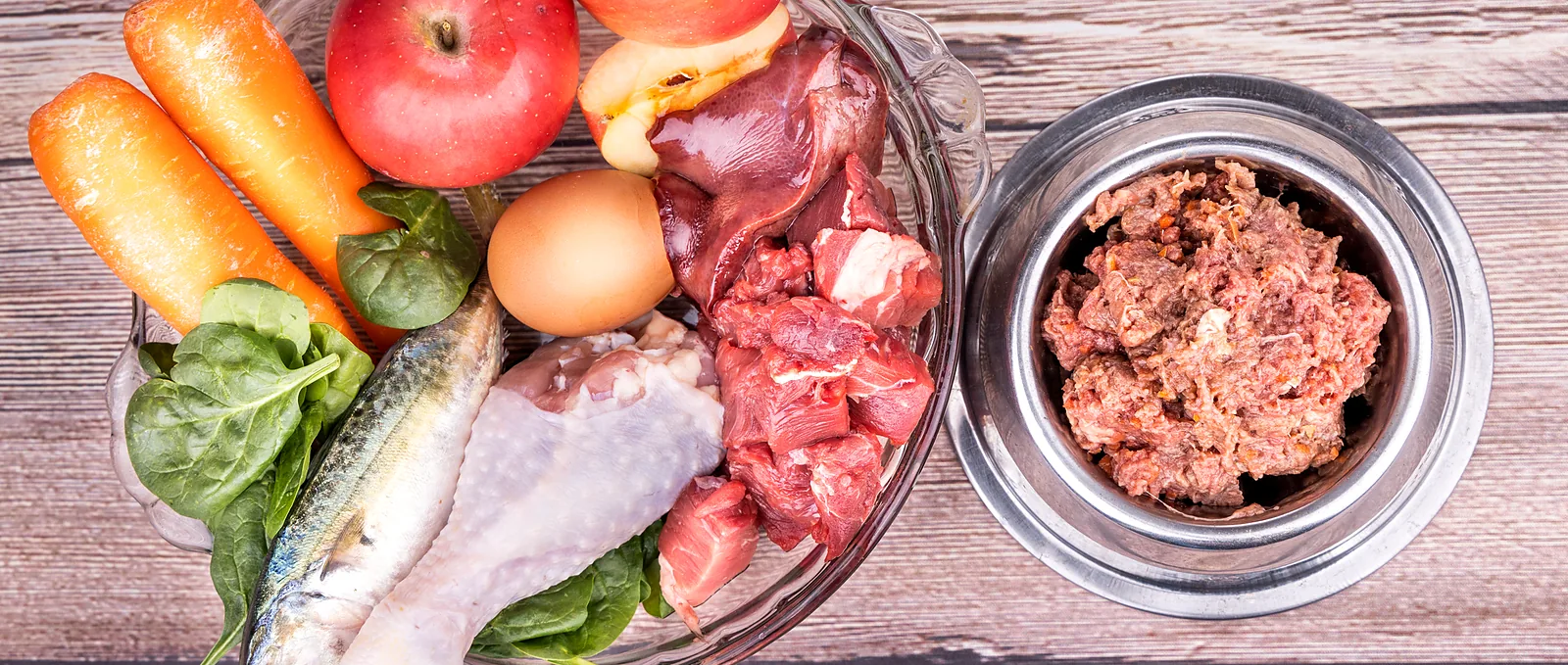 Ingredientes frescos sobre una mesa de madera junto a un bowl con comida cruda